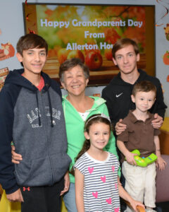 Resident Bette Deans’ family is all smiles. They are from left to right in the back row: Danny Kowalski, age 14, resident Bette Deans, and Matthew Kowalski. In the front row: Jocelyn Perlo, age 6 and her brother Greyson, age 2.